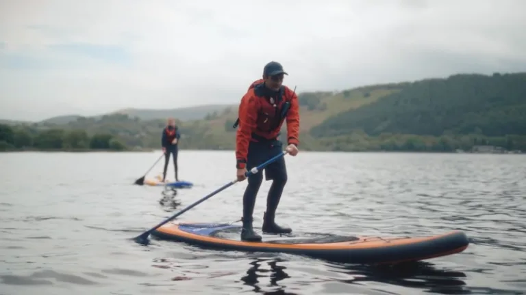 Two paddleboarders on a loch