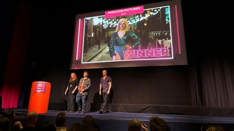 On stage at the Brand Film Awards EMEA 2024, the screen reading Winner above the BPP University film